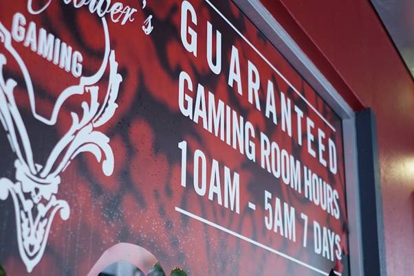 A sign advertising a hotel gaming room hours seven days a week