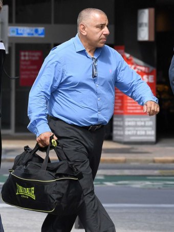 Former Roosters player John Touma arrives at the Supreme Court in Brisbane.
