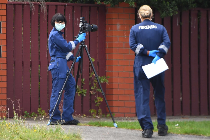Forensic officers at the scene of a murder investigation.