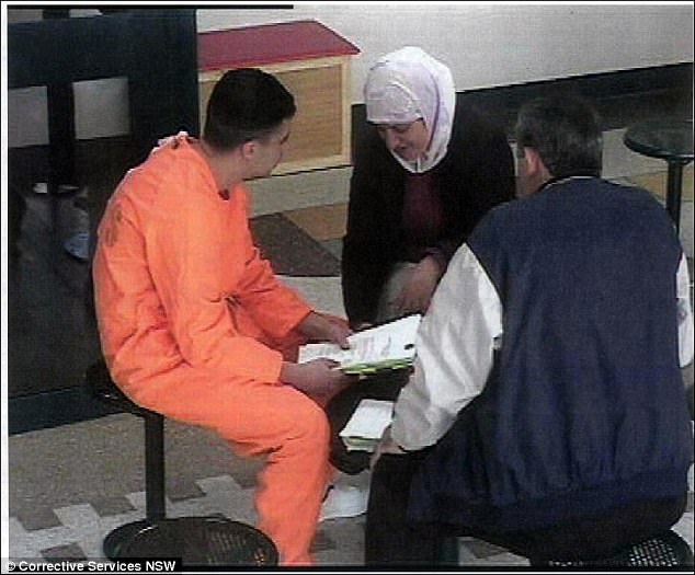 Gang rapist, Bilal Skaf, pictured in the visitors' room at Goulburn Supermax prison sits with his father Mustapha and mother, Baria, who is filmed in the act of secreting in her sock cartoons and letters which Skaf tried to smuggle from the prison to the outside, an act which saw Baria banned from visiting him