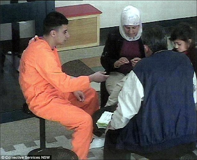 Caught in the act: Gang rapist Bilal Skaf, pictured in the act of trying to smuggle letters out with his mother Baria (centre) is not liked in Goulburn prison where he has been attacked and threatened