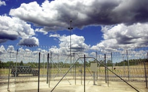 A prison van patrolling outside a fence at a Brisbane correctional centre