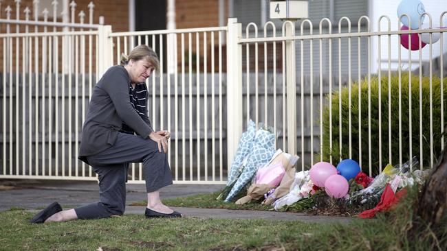 Mary DAmico prays at the front of the home in Burgess St Tullamarine. Picture: David Geraghty