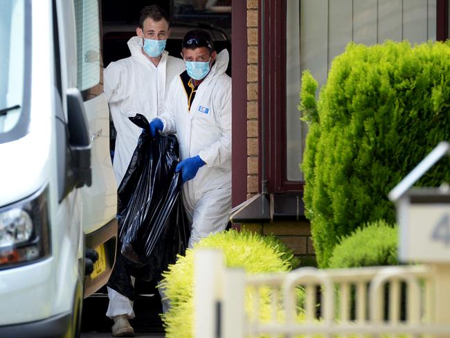 Forensic police at their home on Friday. Picture: Andrew Henshaw